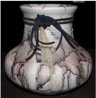 Picture of pot--The squiggles are tail hair burned onto pot as it comes out of kiln.